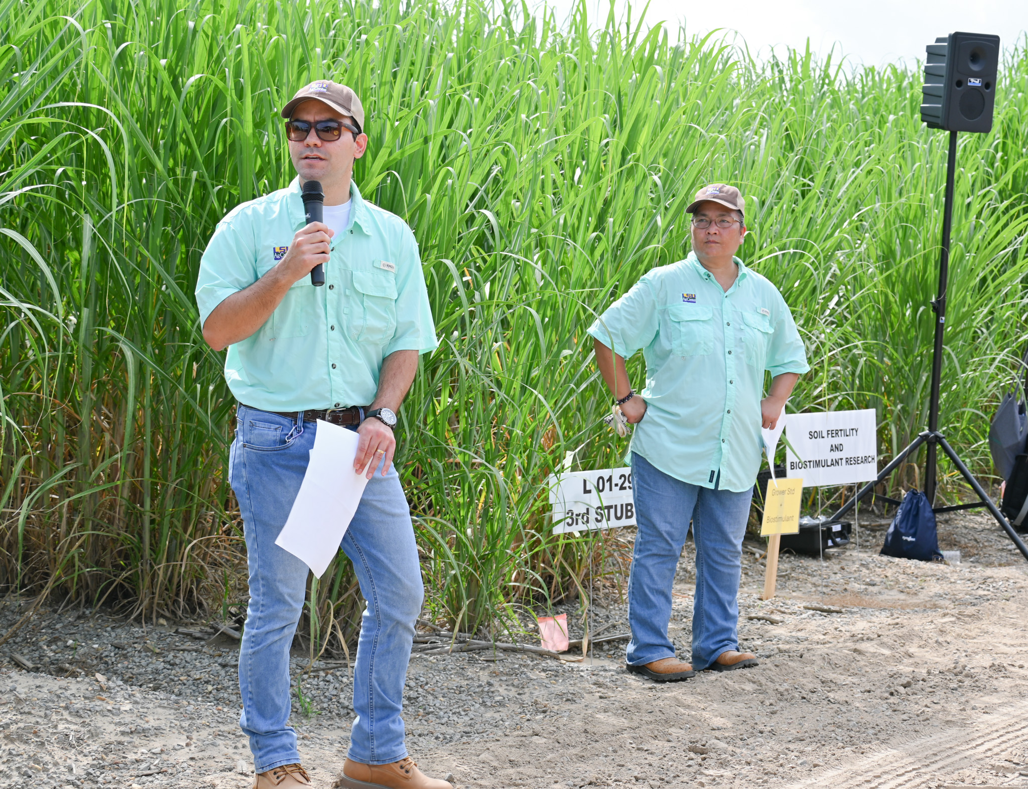 Two people talking at a field day presentation.